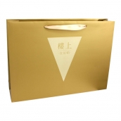 Metallic gold colour paper bag with embossed logo and ribbon handles