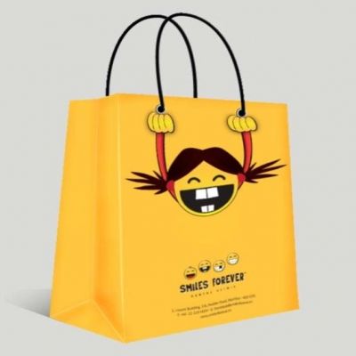 Yellow shopping bag with funny pattern design and silver metal eyelets