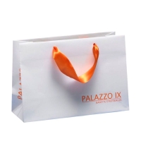 White kraft paper shopping bag with orange colour ribbon handles