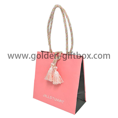 Pink colour shopping bag with tassel decoration and twisted string handles